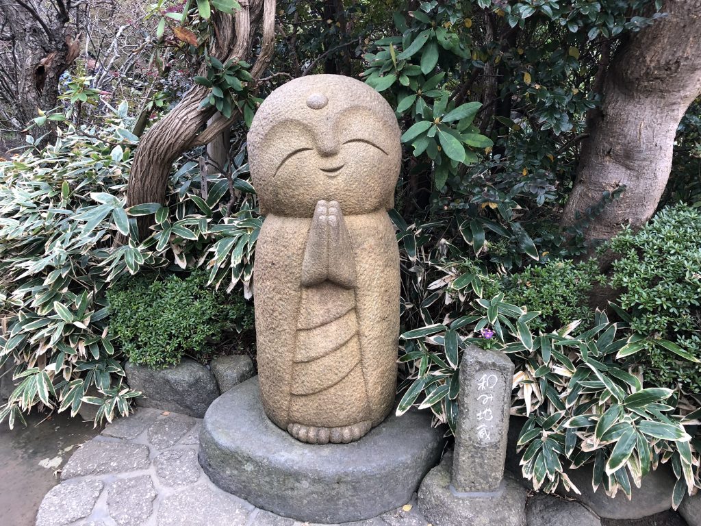 A large, very cutesy statue of a smiling Jizo.