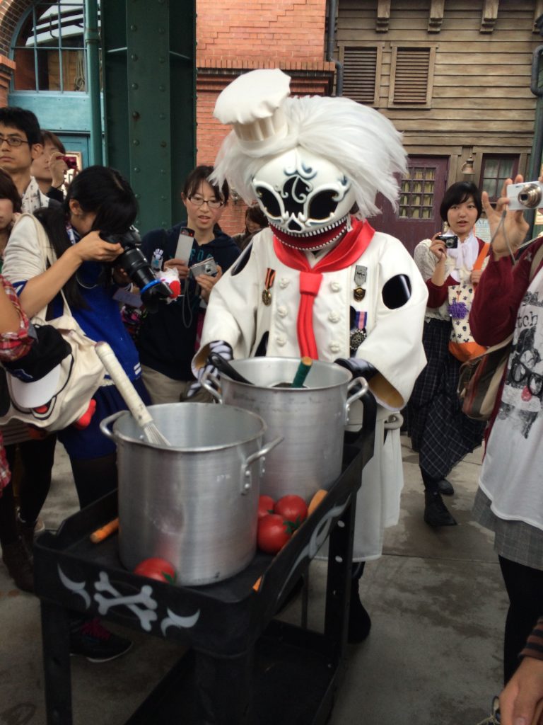 A Dia de los Muertos inspired character dressed up like a chef walking around Tokyo DisneySea.