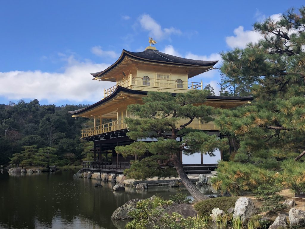 A glimpse of the pavilion from another angle. Trees are in the foreground.