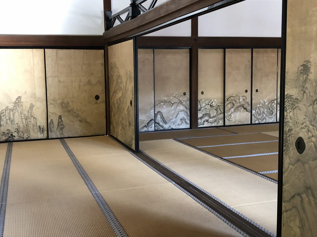 A glimpse inside the temple. Though it's a simple tatami room, the screens are painted with scenes of mountains and trees.