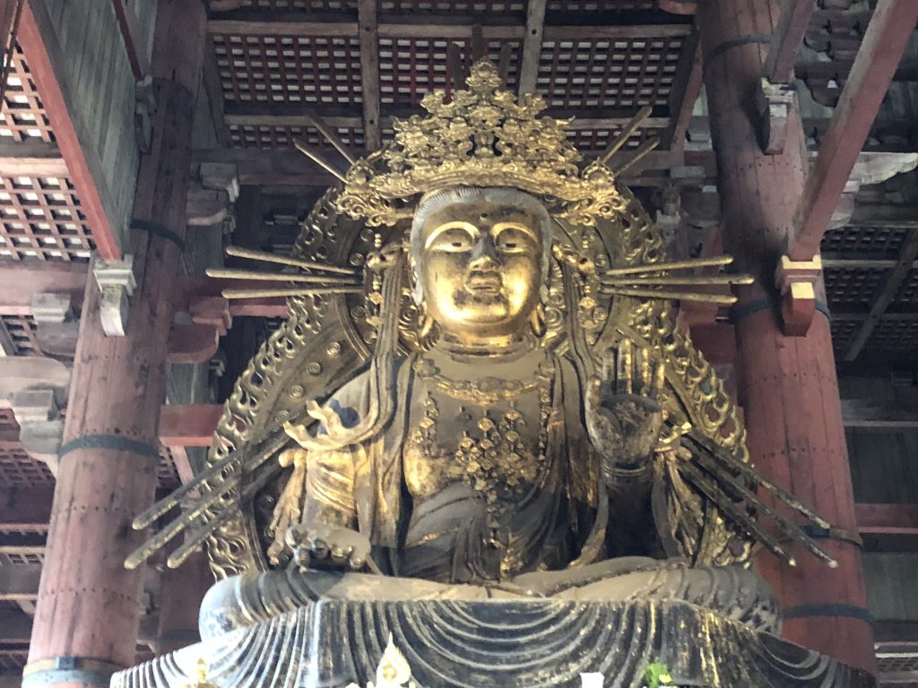 A golden statue of a seated Kannon.