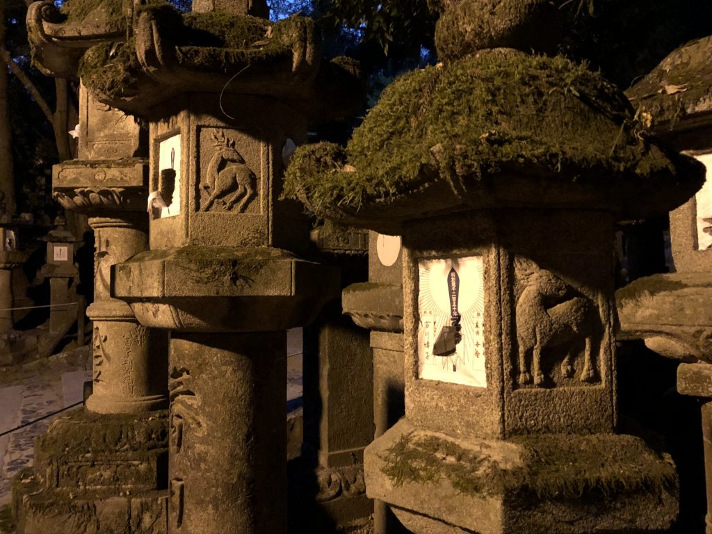 Stone lanterns with deer carved into them.